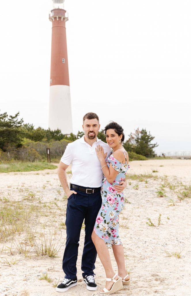 couple standing by lighthouse