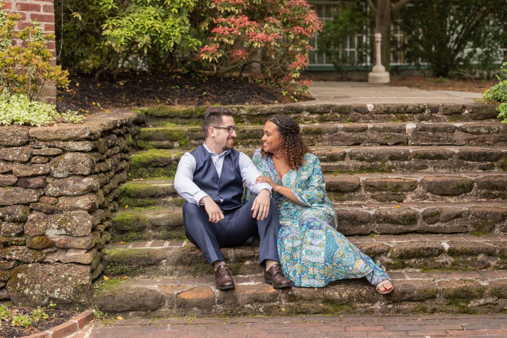engaged couple sitting on steps