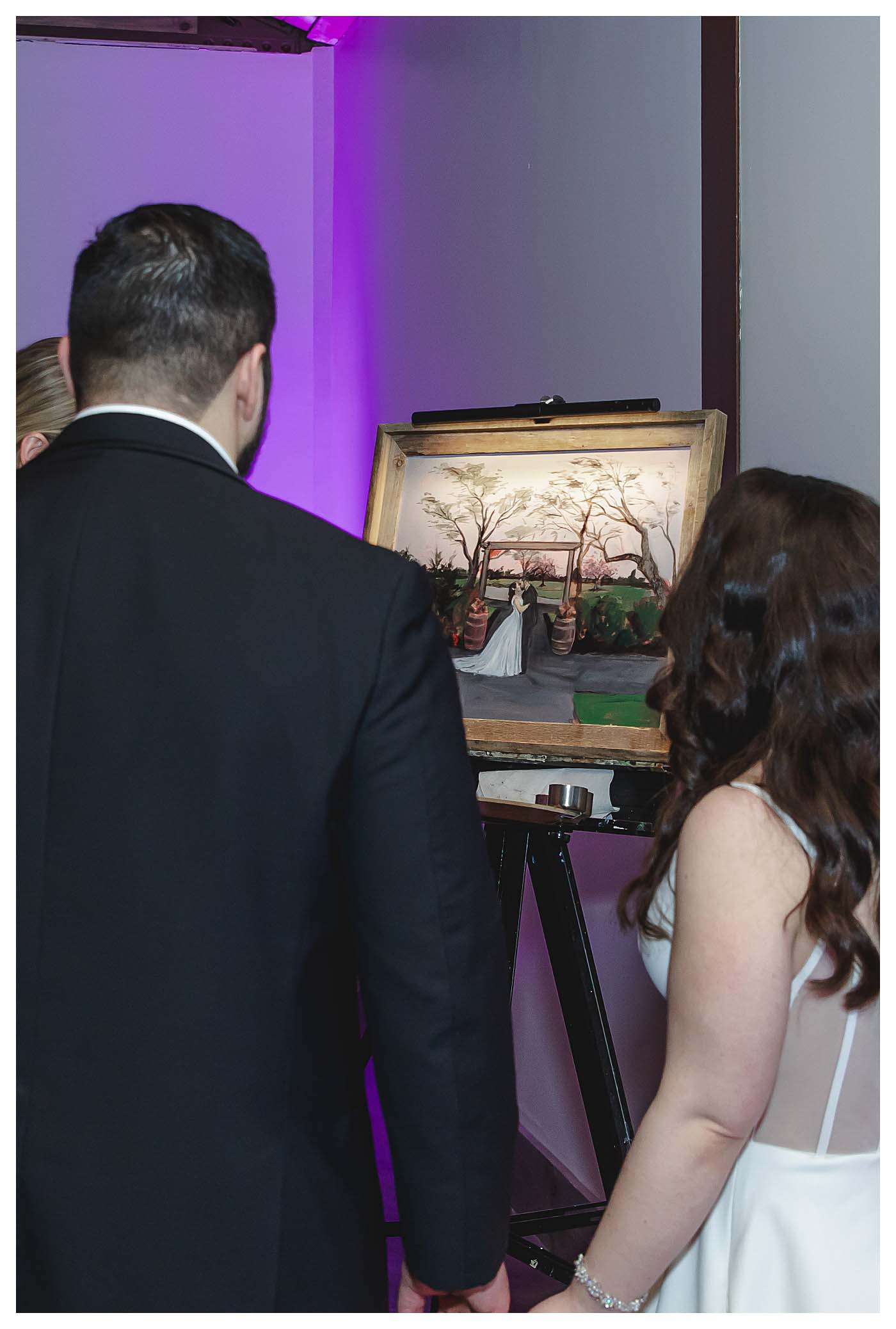 wedding couple looking at wedding painting