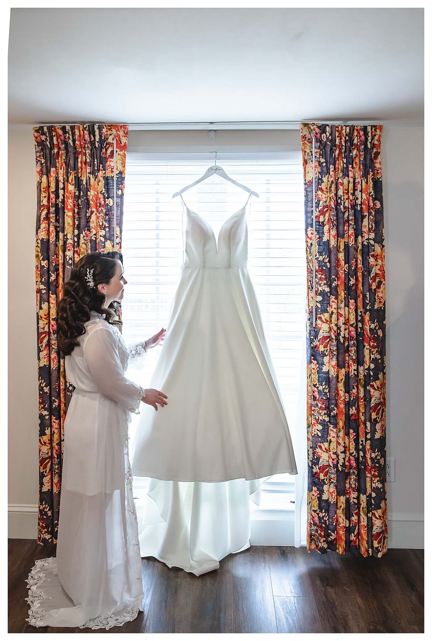 bride looking at wedding gown