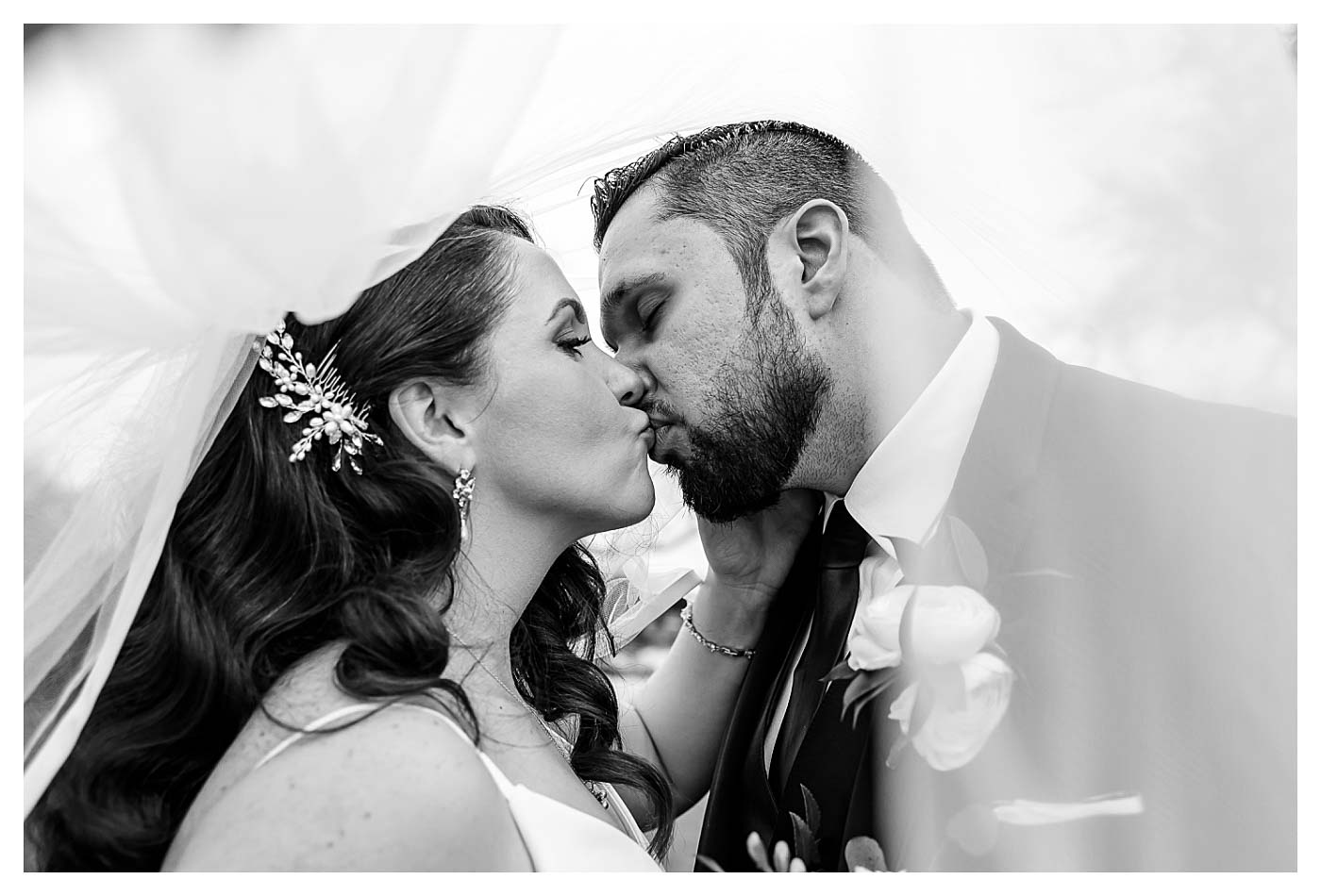 black and white photo of couple kissing