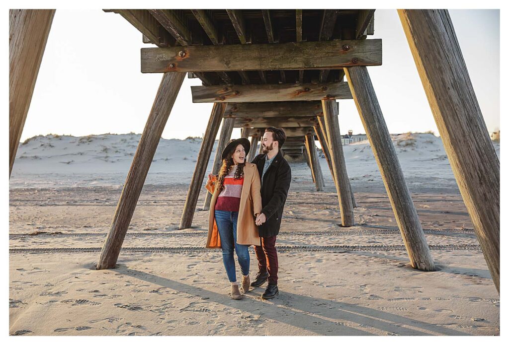 engagement couple under pier