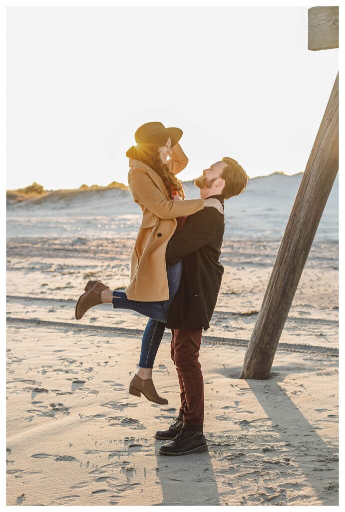 couple posing for pictures on beach Avalon Beach Engagement Session