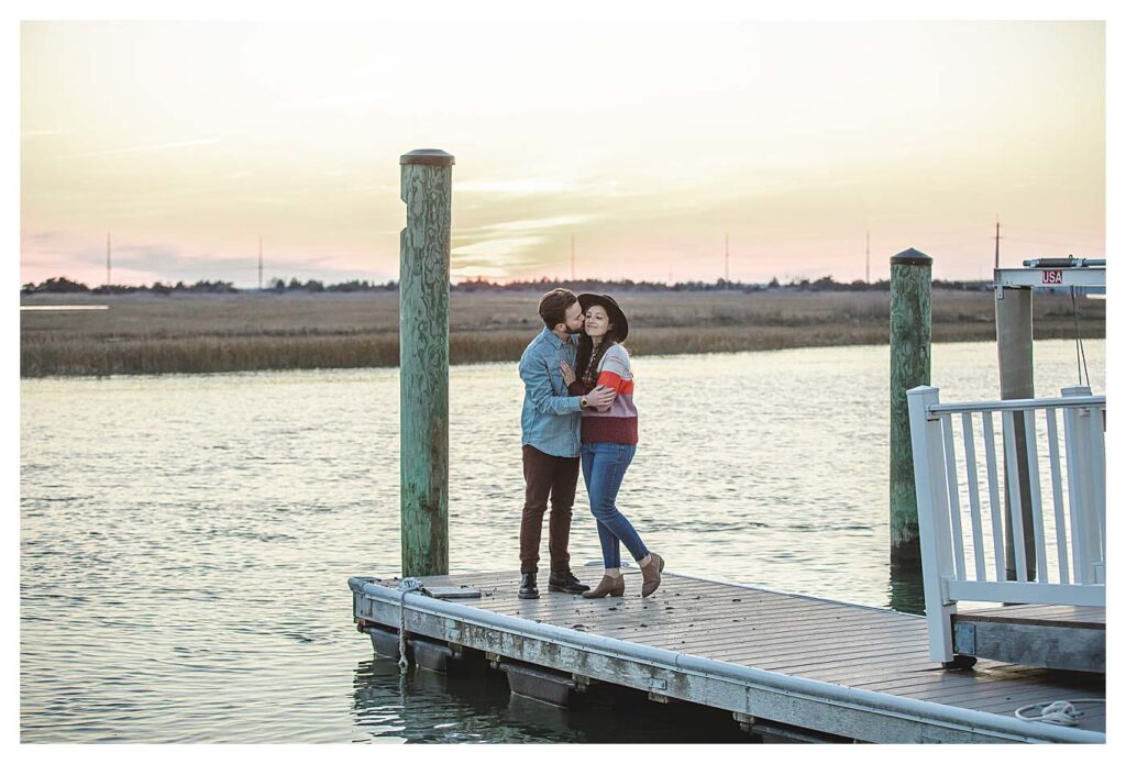 couple on dock with sunset Avalon Beach Engagement Session