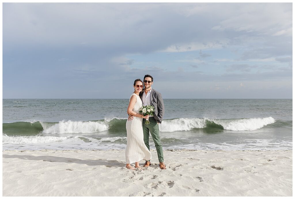 wedding couple standing by ocean in cape may