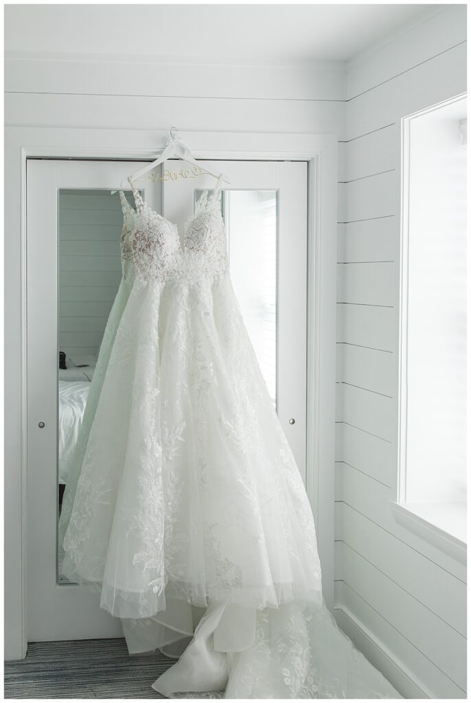 Lauren's wedding dress hanging on the door 