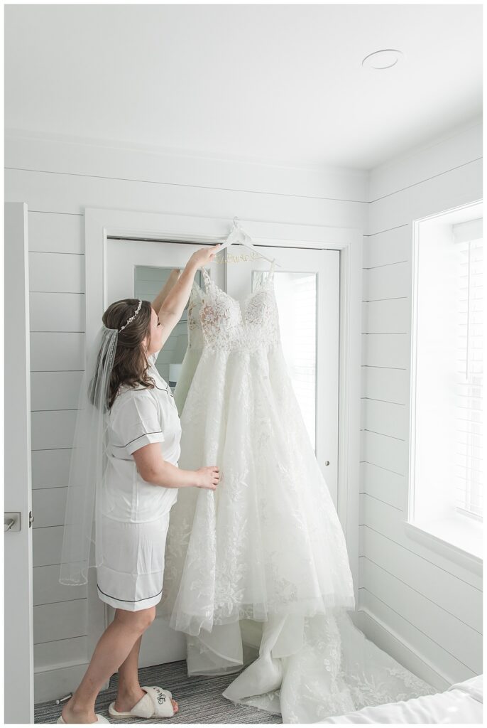Lauren looking at her wedding gown on the morning of her wedding at the ICONA Windrift
