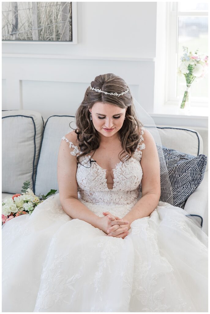 Lauren sitting on the couch on the morning of her fall wedding day