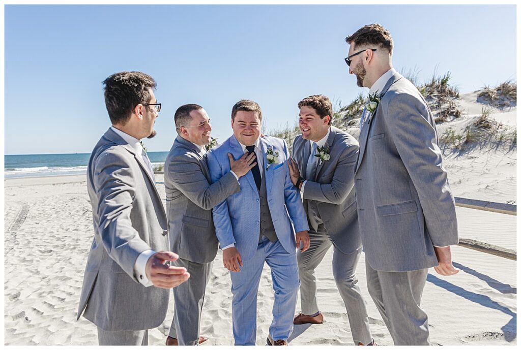 Zach with his groomsmen on his wedding day on the beach in Avalon