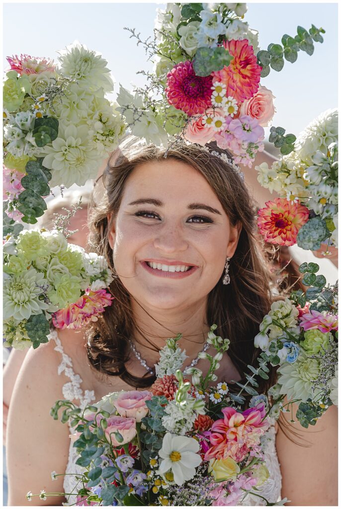 Lauren on her wedding day surrounded by all of the bouquets