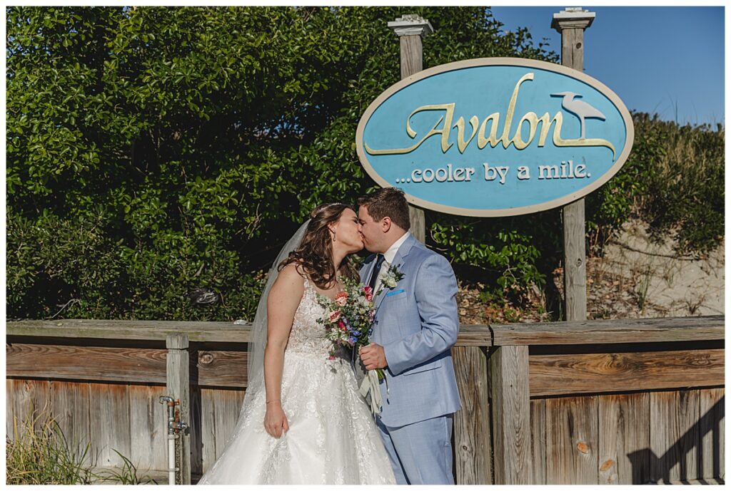 couple kissing in front of the Avalon Sign