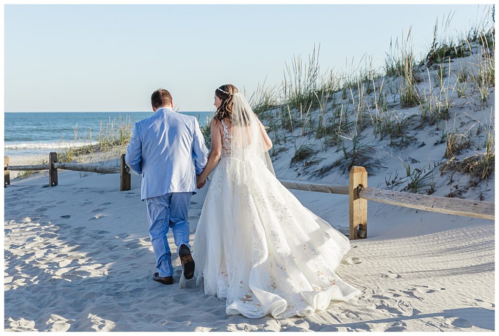 Lauren and Zach walking in the sand after their beach ceremony in Avalon, NJ