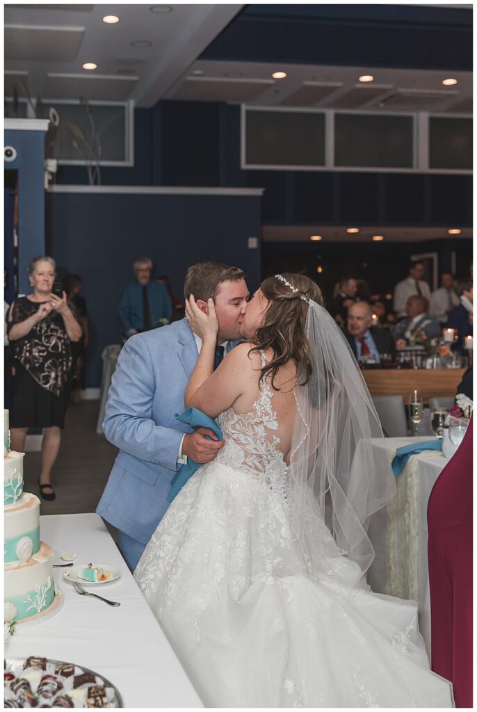 Wedding couple kissing after their cake cutting