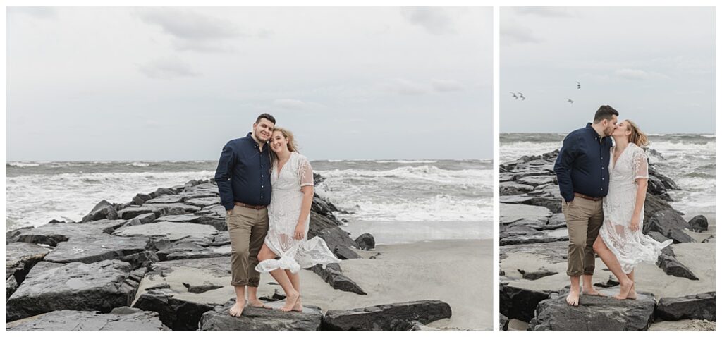 couple standing on rock jetty in ocean city

