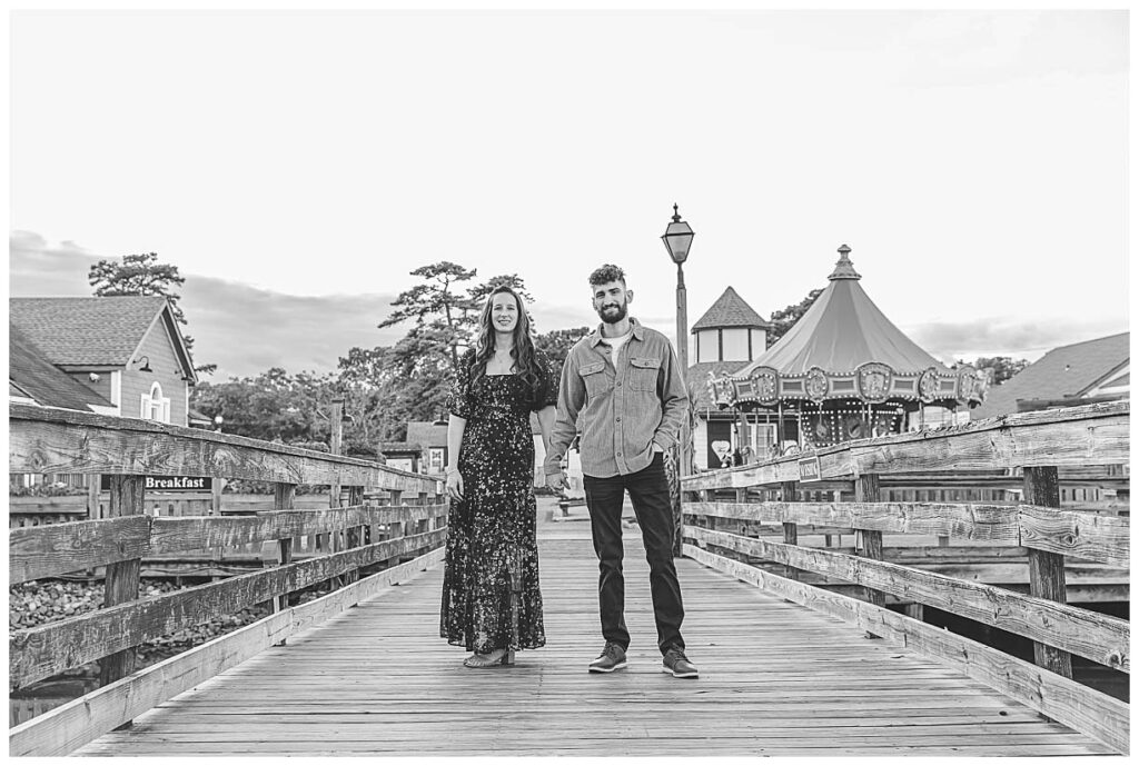 couple posing on bridge for photos