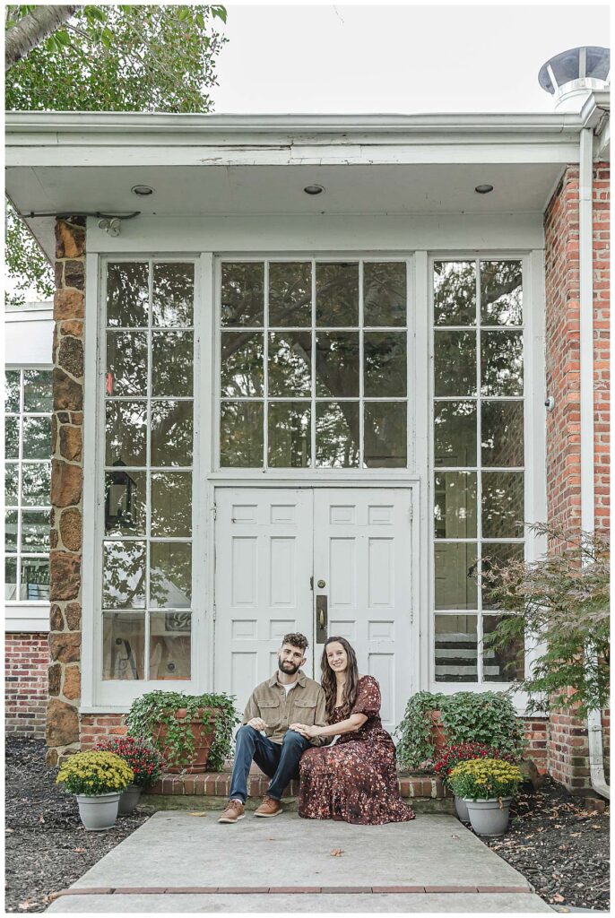 engaged couple posing for photos in front of a white door at smithville.