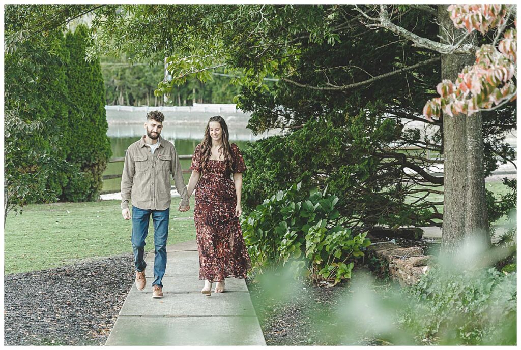 couple walking on path during engagement session