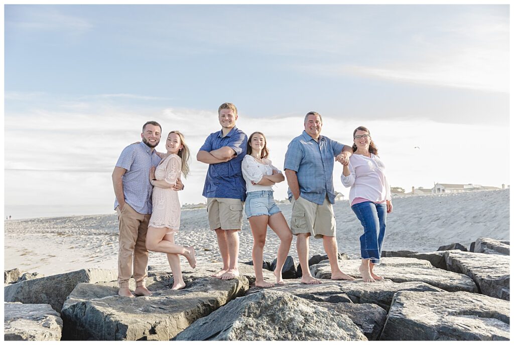 family posing on a rock jetty in Ocean city