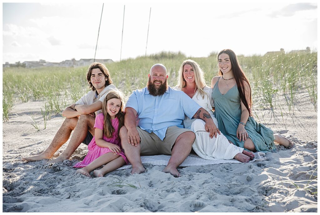 Family sitting on beach in Ocean City NJ for their family session