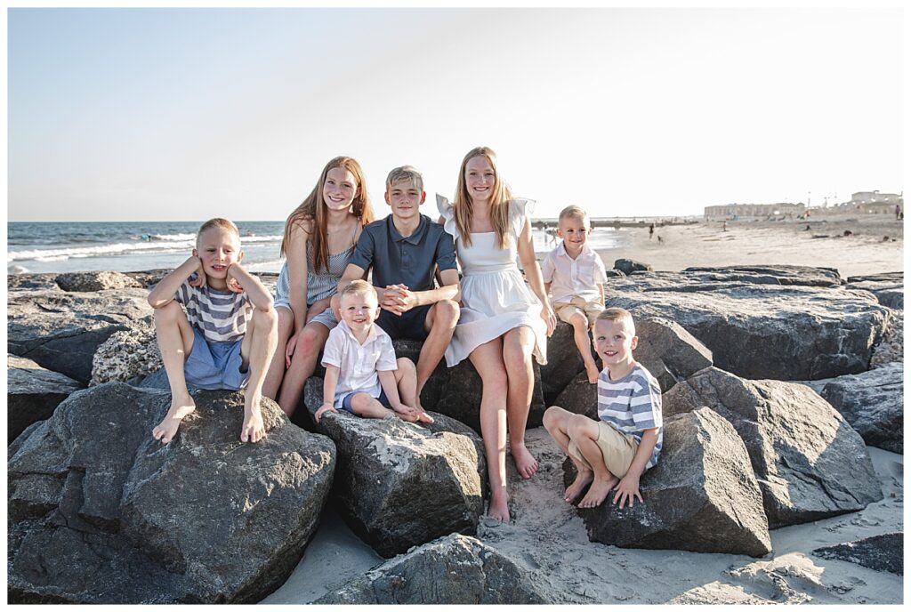 Siblings and cousins sitting on the rock jetty in Ocean City Nj