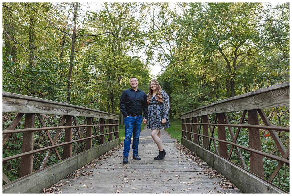 Mercer county engagement session. couple standing on bridge for photos