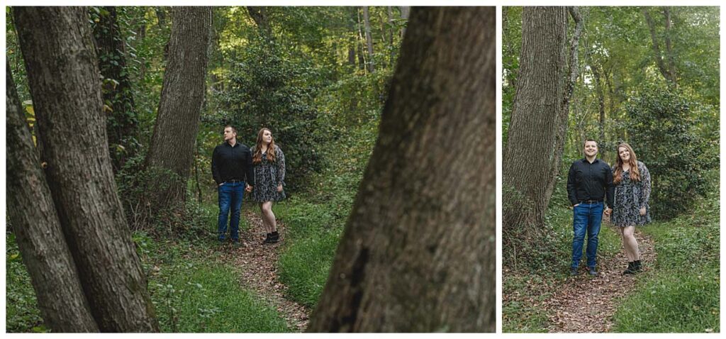 engaged couple posing on a wooded path for their engagement session