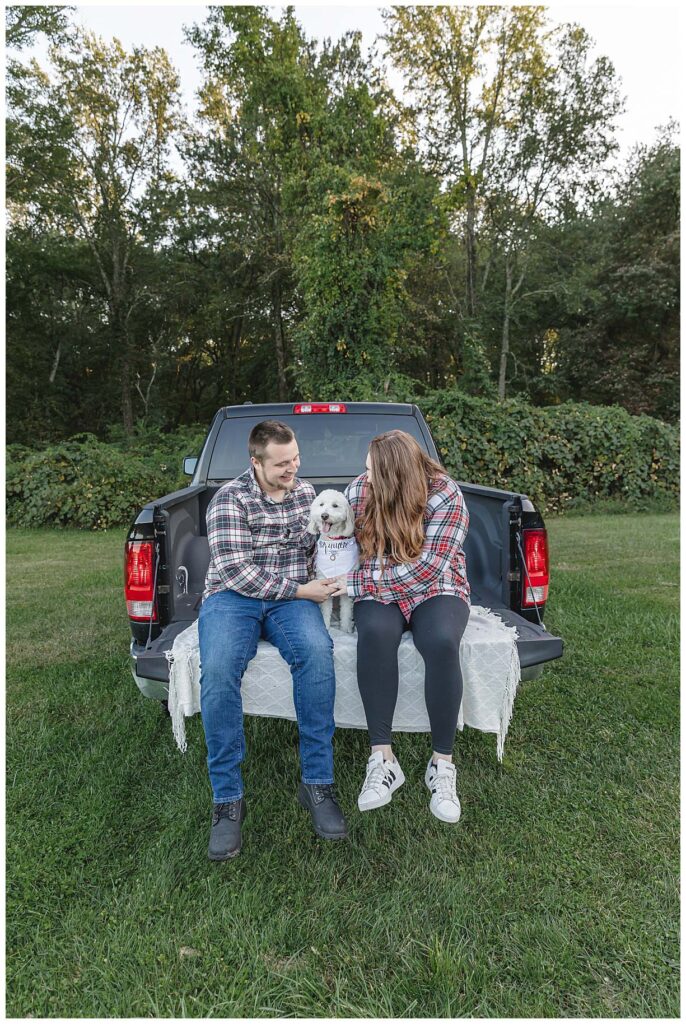 cpuple sitting in pickup truck posing for engagement pictures
