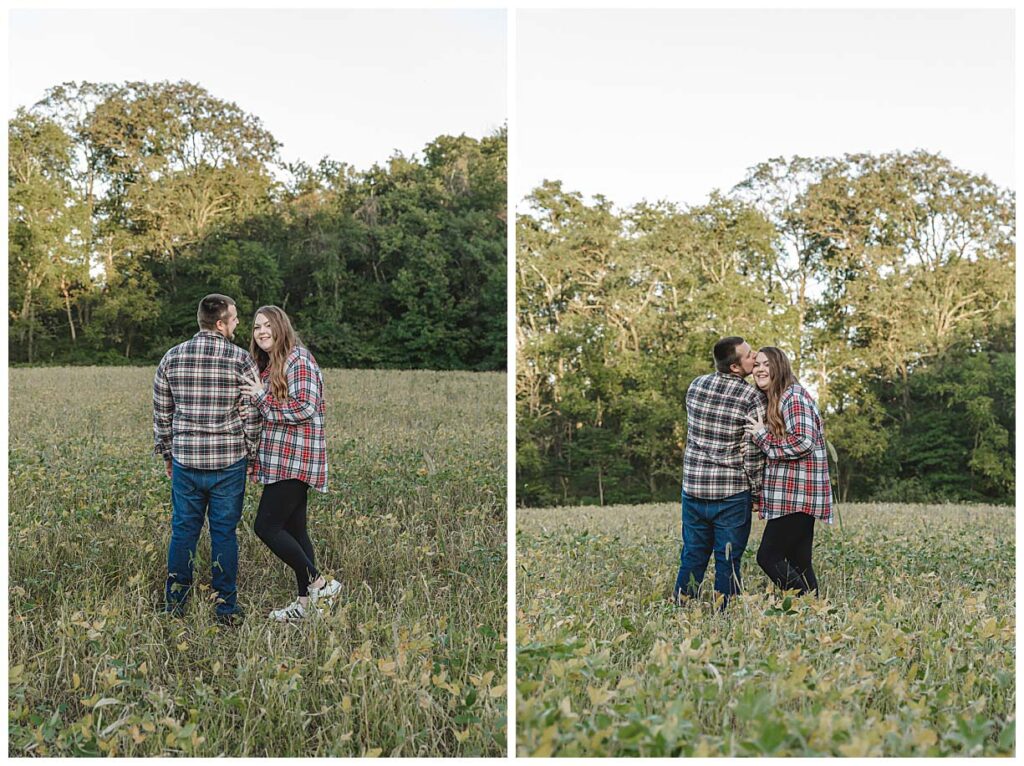 engaged couple kissing in field during an engagement session