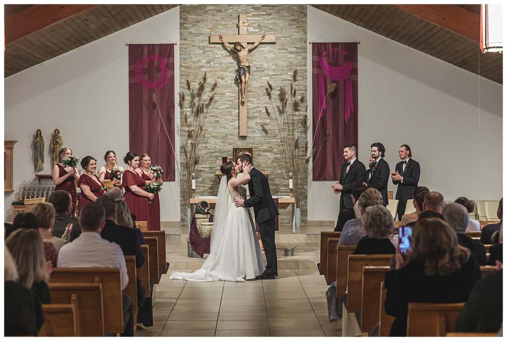 couple kissing in a church during a wedding