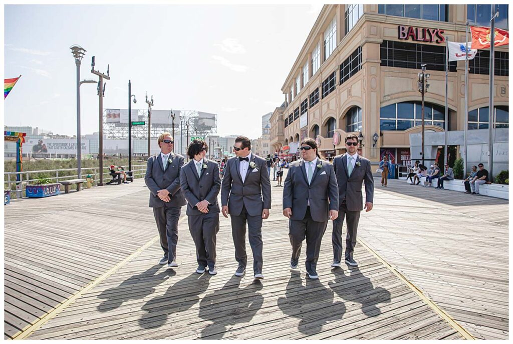 groom and his groomsmen on the boardwalk in atlantic city nj