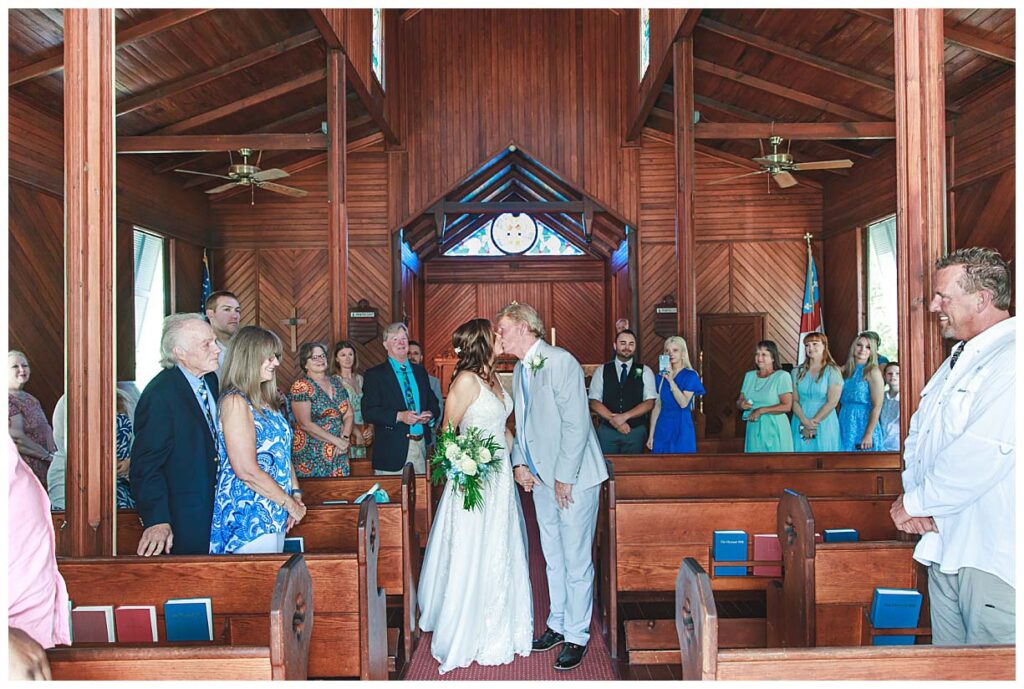 wedding couple kissing in a church