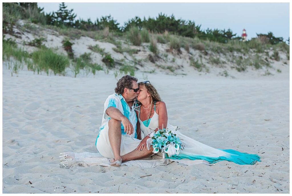 wedding couple sitting on beach in cape may nj