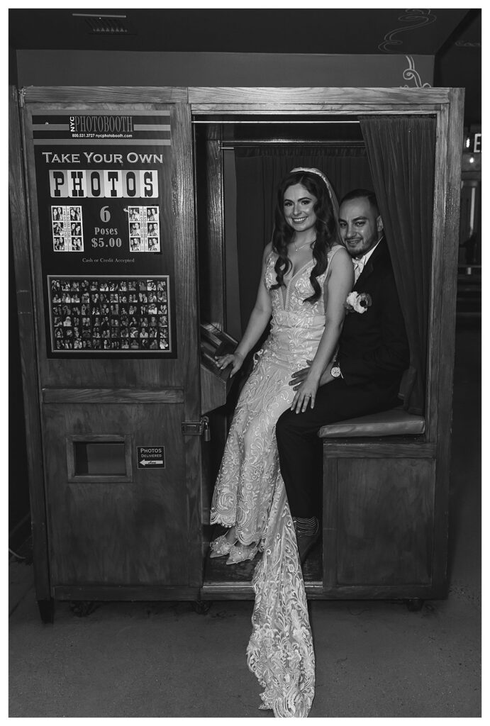 black and white photo of couple in the photo booth