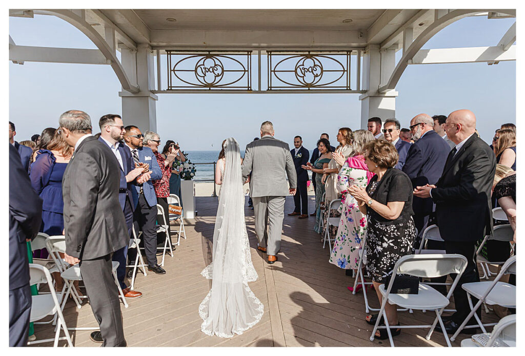 bride walking towards groom at ceremony in long branch