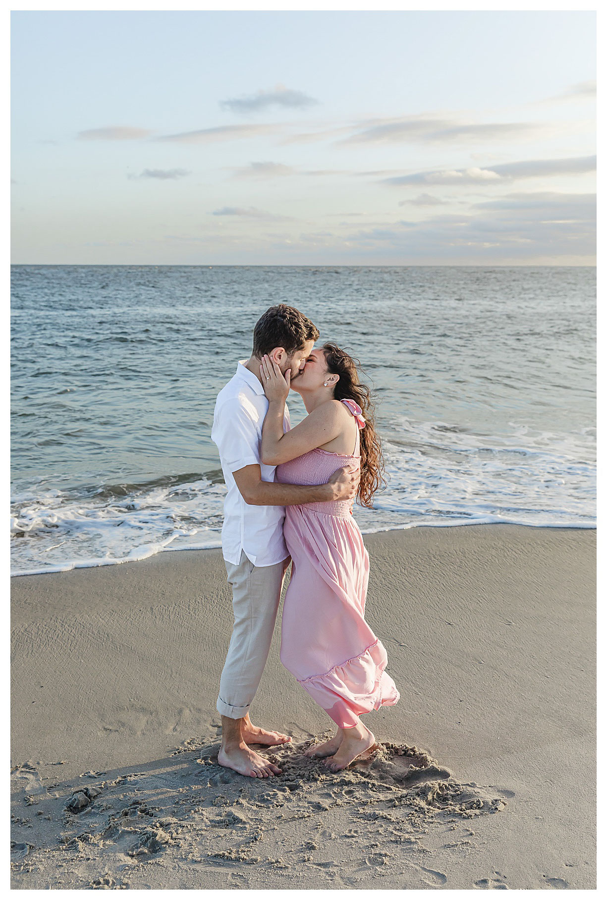 couple kissing on beach in cape may