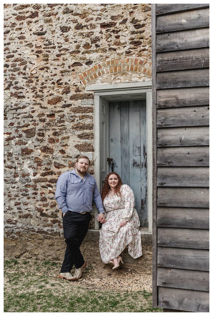 couple sitting near a blue door at batsto