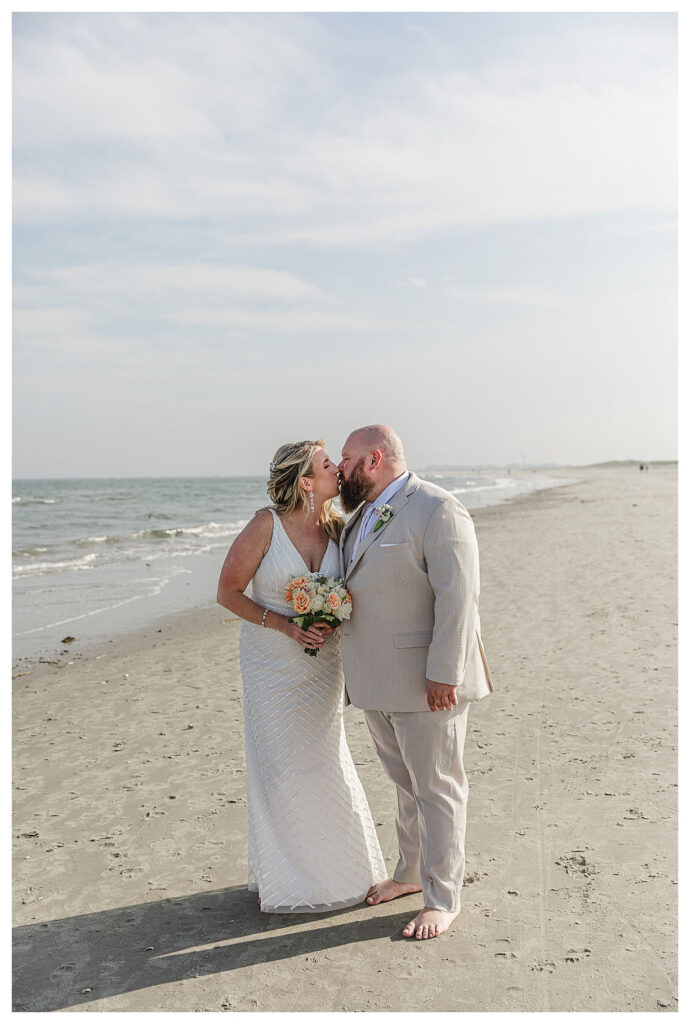 wedding couple kissing on beach in OCNJ