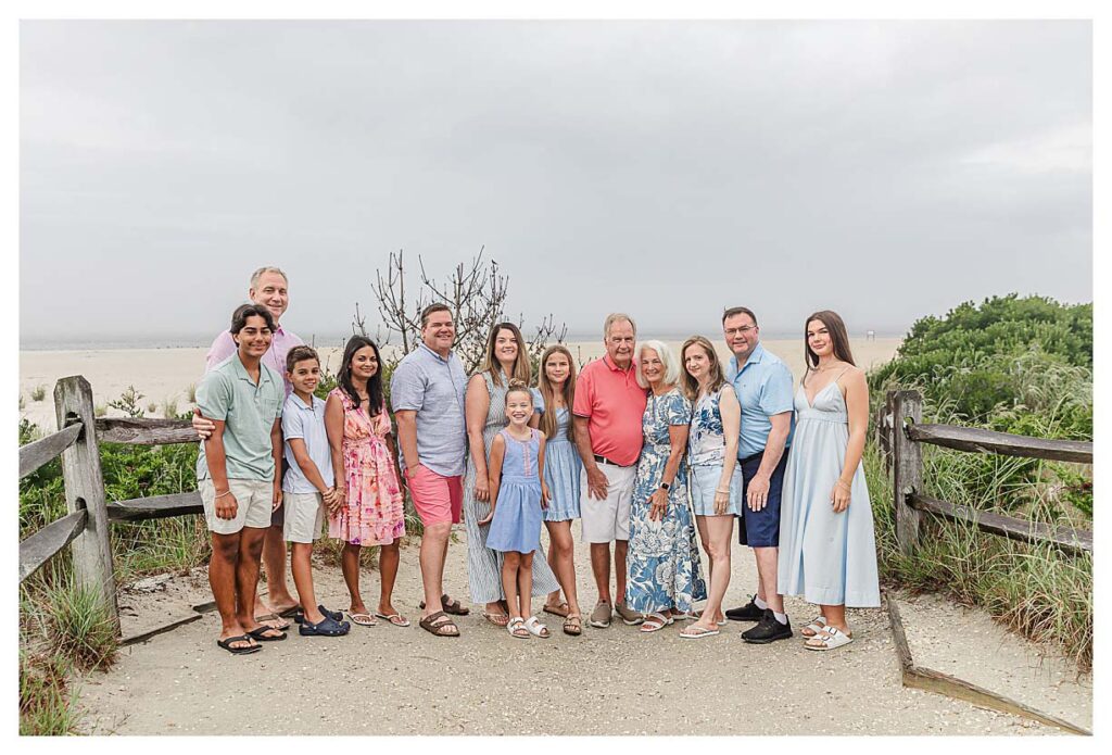 family standing on a beach path in cape may for their south jersey family beach session