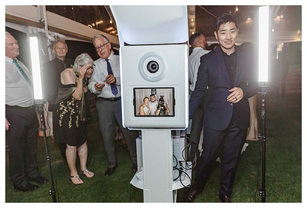 photo of photographer with the bride and groom