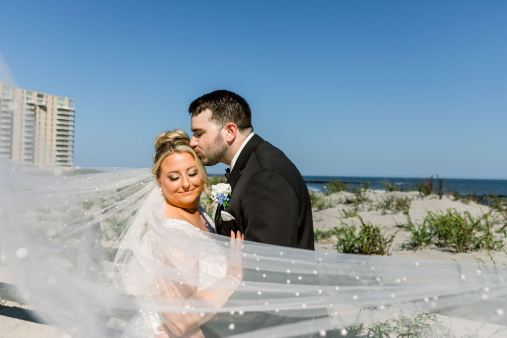 “Ocean City NJwedding photographer couplekissing on beach